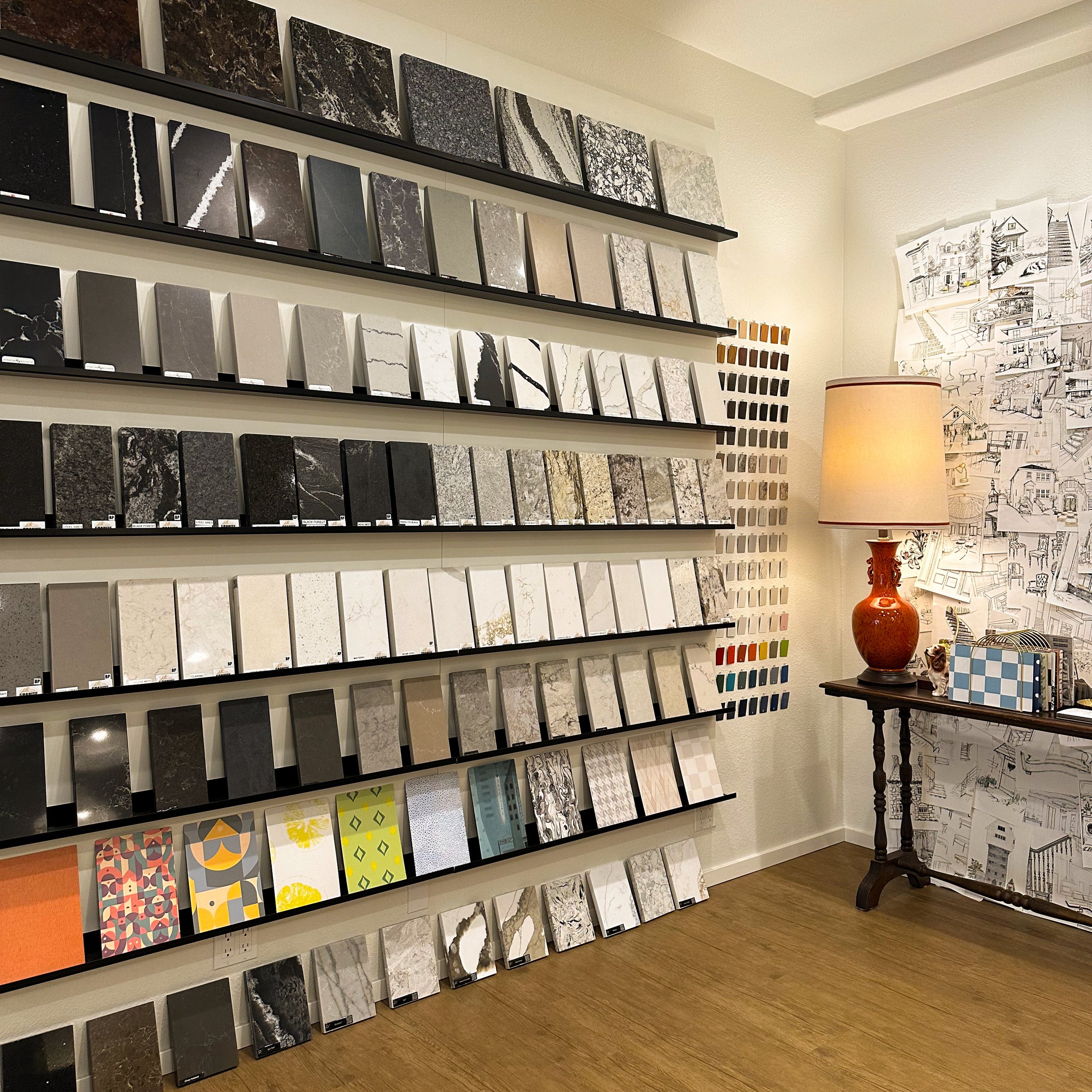 Wall of surface samples beside a table lamp in the showroom